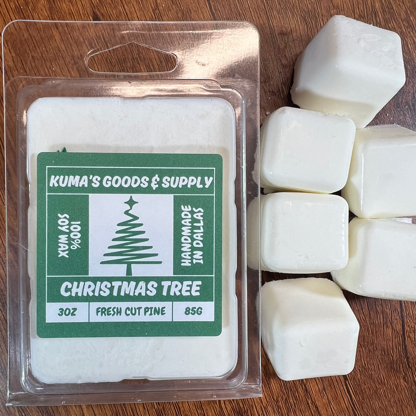Kuma's Goods & Supply Christmas Tree wax melts on a wooden surface