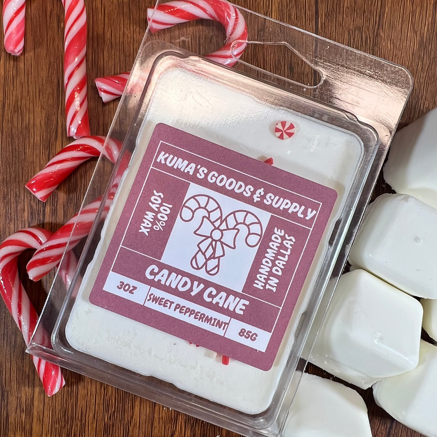 Kuma's Goods & Supply candy cane wax melts on a wooden surface with candy canes.