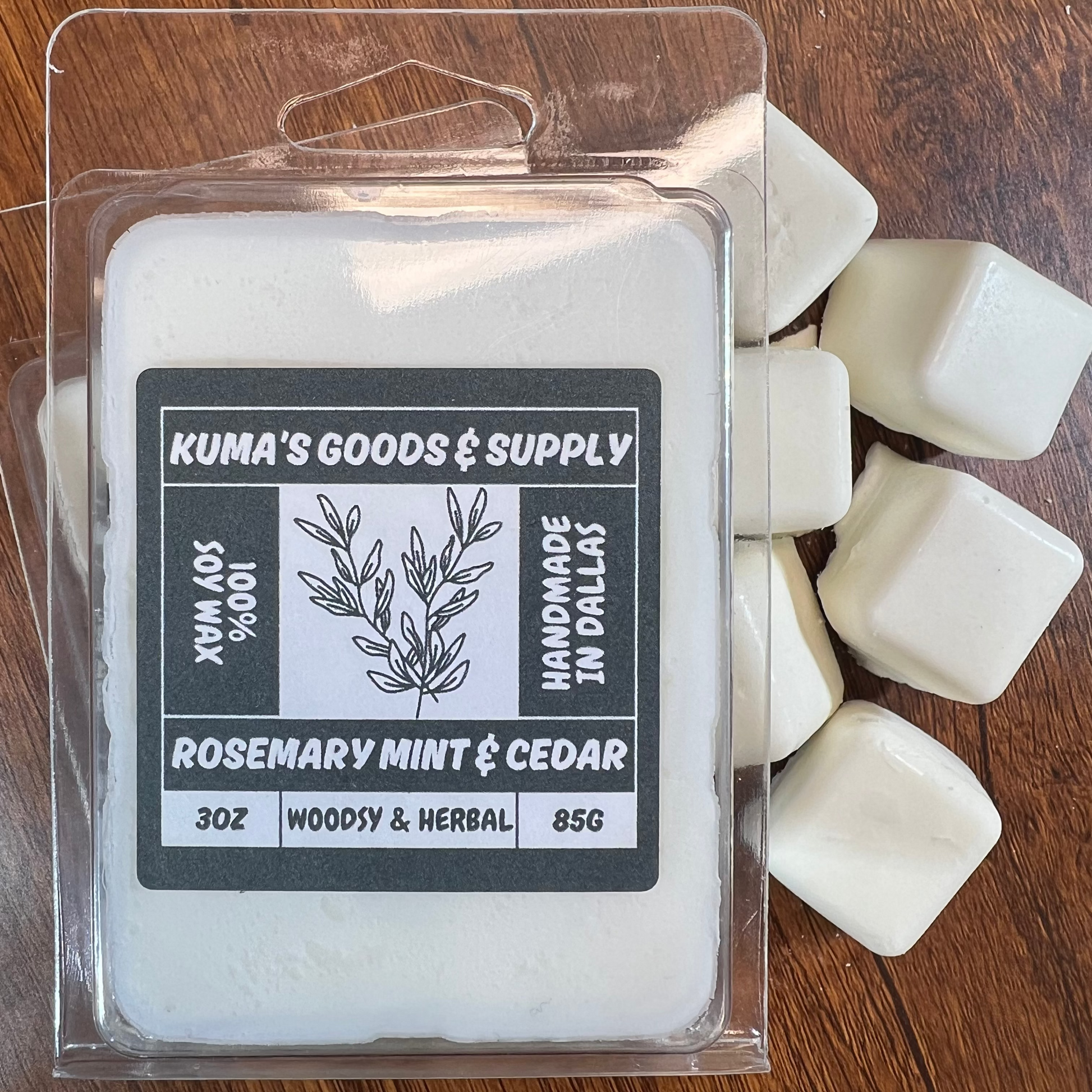 Kuma's Goods & Supply wax melt packaging on a wooden surface