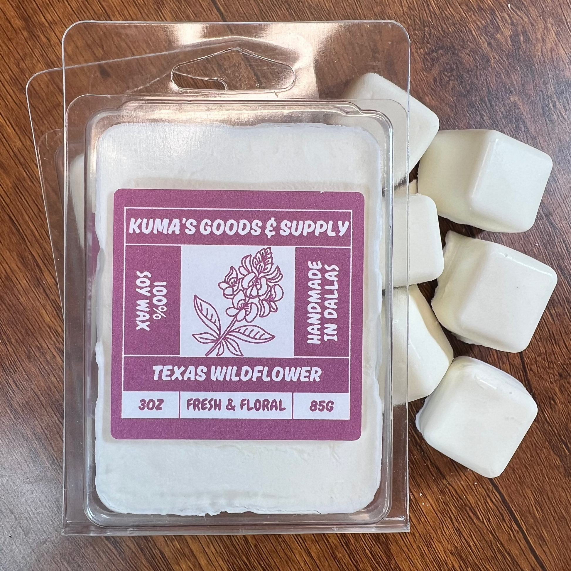 Kuma's Goods & Supply wax melts on a wooden surface