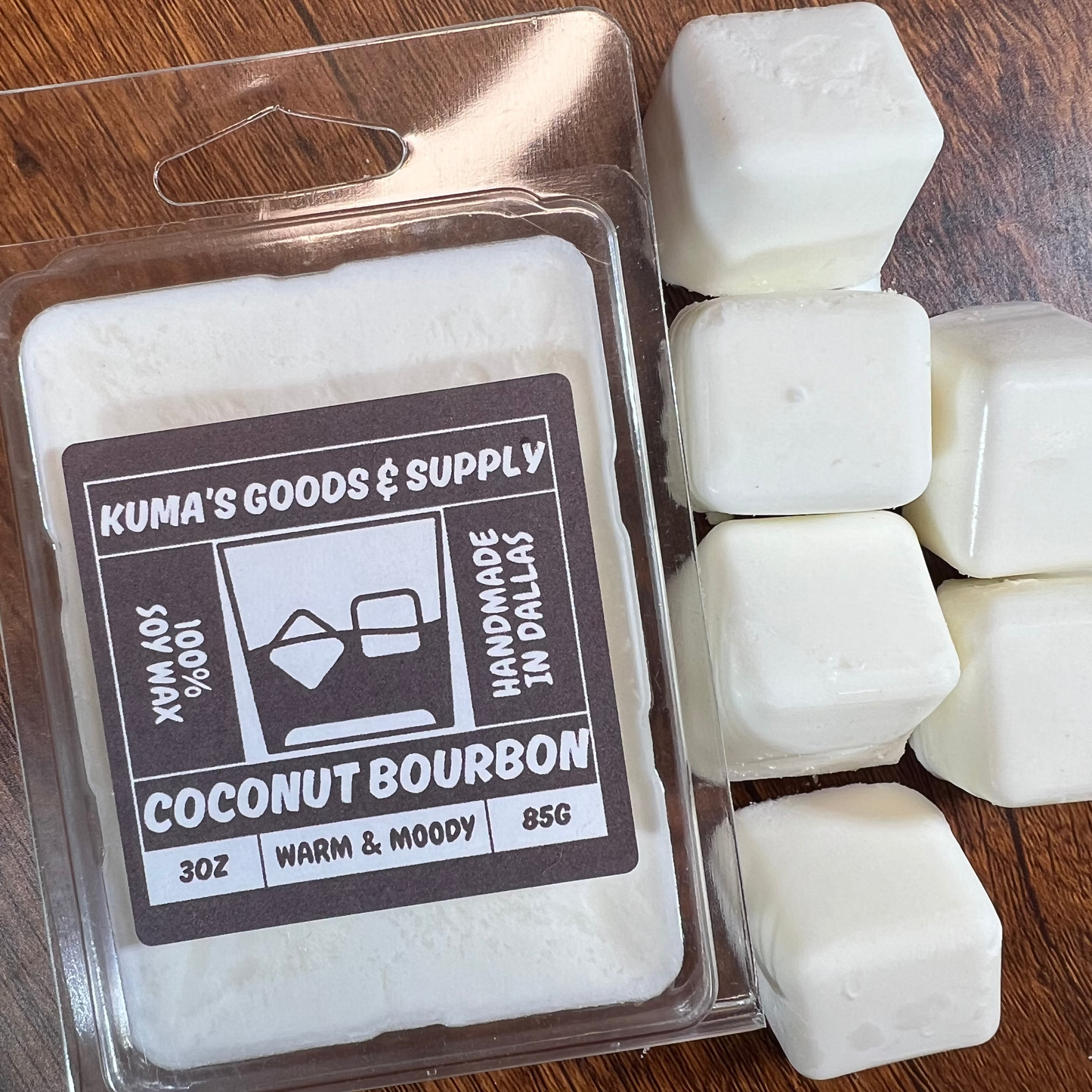 Kuma's Goods & Supply coconut bourbon wax melts on a wooden surface
